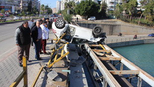Kaza yapan otomobil kanal korkuluğunda asılı kaldı