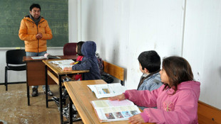 Yol kapanınca öğrencilerini kucağında taşıyor