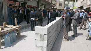 Belediyeyi protesto için yol ortasına duvar ördü