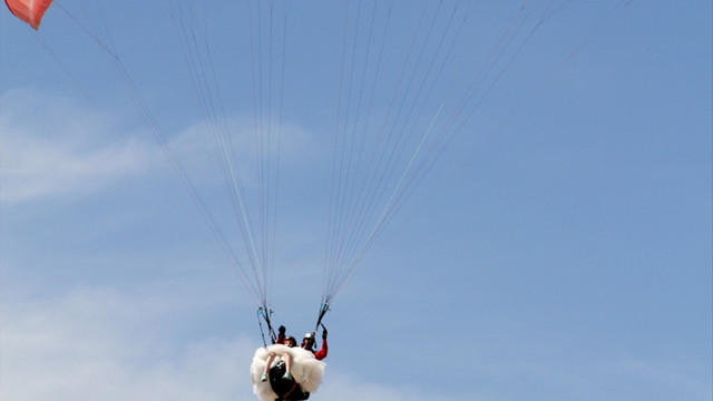 Yeni evli çiftten gelinlik ve damatlıkla yamaç paraşütü